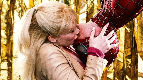 From Spider-Man 3, Peter Parker hangs upside down over a stage for a Spider-Man rally and lets Gwen Stacy kiss him after the crowd eggs them on.